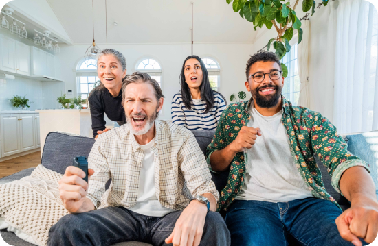 Family and friends excited watching TV together
